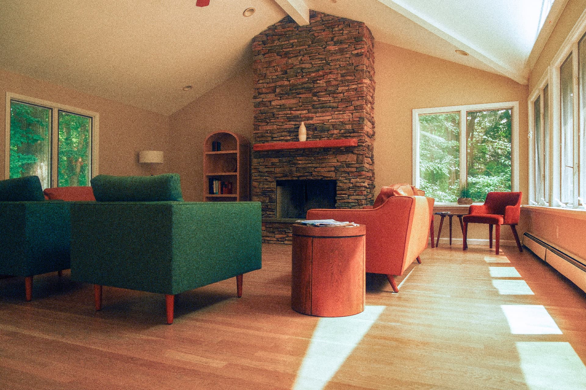 Sunlit living room with a stone fireplace and residents reading together
